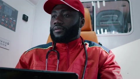 Black paramedic using tablet and speaking Stock Footage 167966717