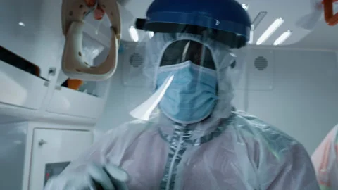Black paramedic working in ambulance during pandemic Stock Footage 167964196