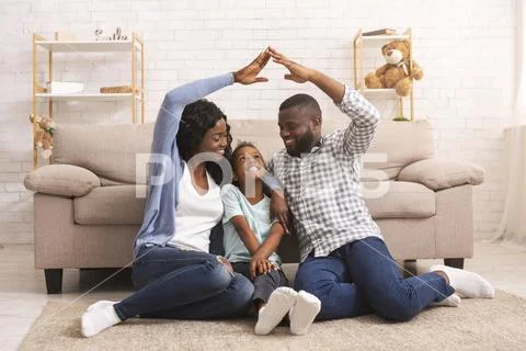 Black Parents Making Symbolic Roof Of Hands Above Little Daughter's Head