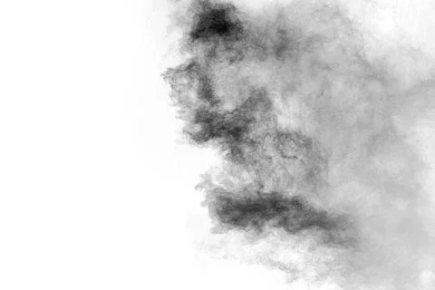 Black particles splatter on white background. Black powder dust burst. Stock Photos