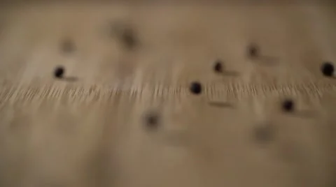Black peas fall on a table surface Stock Footage 64544356
