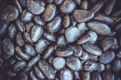 Black pebbles; beautiful texture background with copy space Stock Photos