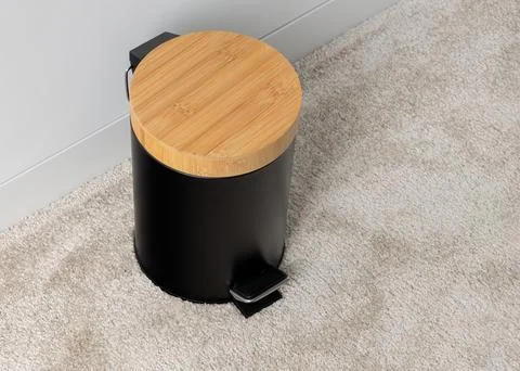 Black Pedal Trash Can with Bamboo Lid on Carpet Stock Photos