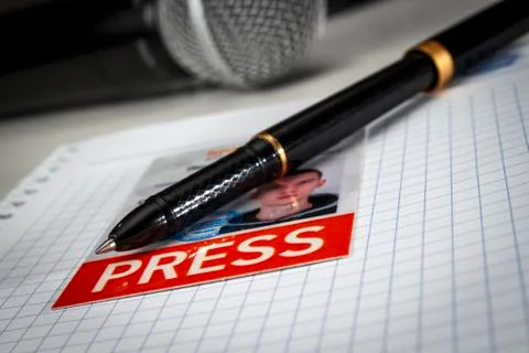 A black pen with a journalistic ID on a notebook Stock Photos