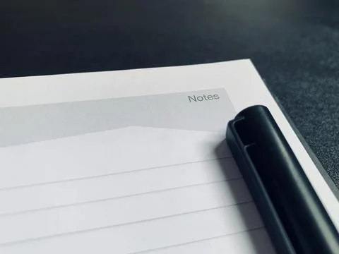 Black Pen Lying on Open Lined Notepad Page Notes Header Close Up View Stock Photos