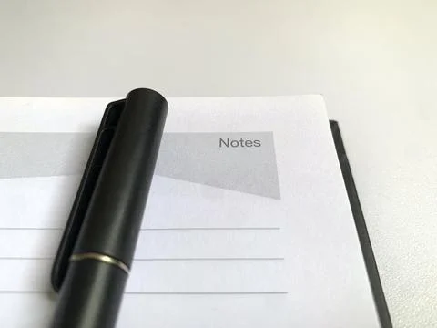 Black Pen Lying on Open Lined Notepad Page Notes Header Close Up View Stock Photos