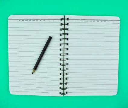 Black pen on top of a open note paper diary isolated on a white background Stock Photos