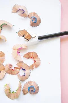 Black pencil next to sharpener on blank page Stock Photos