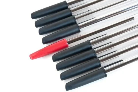 Black pens with a red one Stock Photos