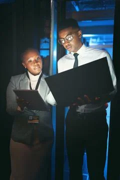 Black people, programming and laptop in server room at night for research, .. Foto stock