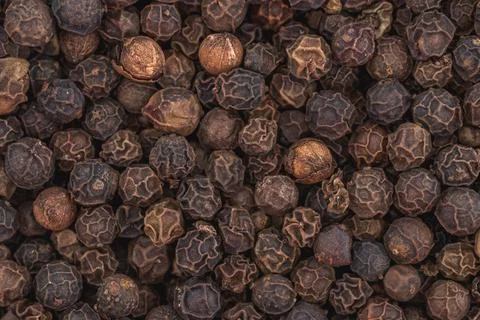 Black pepper background close up. Stock Photos
