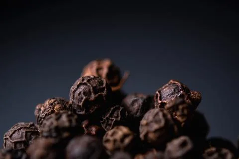 Black pepper close-up on a blue background Foto stock