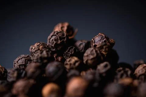 Black pepper close-up on a blue background Stock Photos