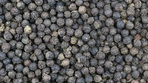 Black pepper close up. Front of the camera rotates plate with black pepper Stock Footage