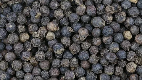 Black pepper close up.  Front of the camera rotates plate with black pepper Stock Footage 69786490