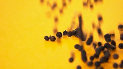 Black Pepper Dropping On Orange Surface, Slow Motion 250 FPS Видео 92135075