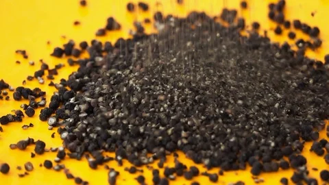 Black Pepper Dropping On Orange Surface, Slow Motion 250 FPS Stock Footage 92135089