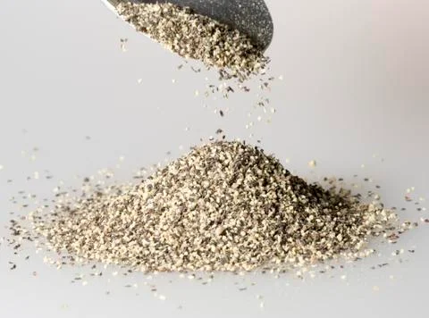 Black Pepper Falling from Tablespoon Stock Photos