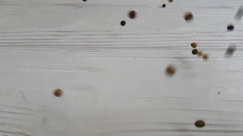 Black pepper peas spice flies on a white background, Stock Footage 87399008