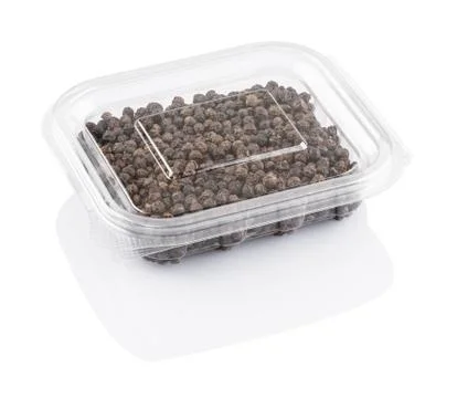 Black pepper seeds in a transparent plastic container Stock Photos