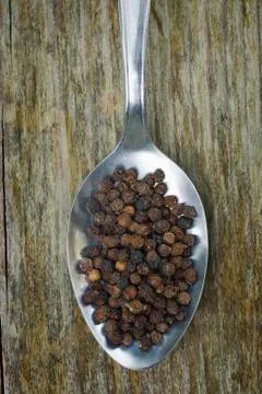 Black pepper with spoon Stock Photos