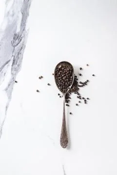 Black pepper in spoon Stock Photos