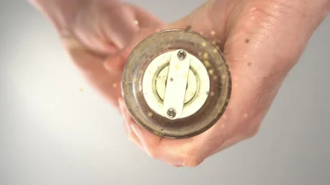 Black pepper is sprinkled on a transparent surface, bottom view. Stock Footage 173166876