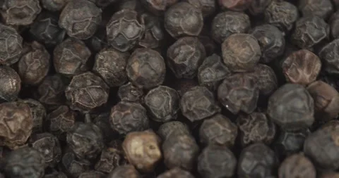 Black peppercorns closeup rotating selective focus Stock Footage 156486525