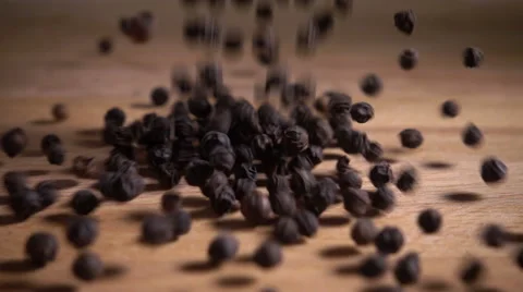 Black peppercorns fall in slow motion Stock Footage 58034794