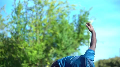 Black person does exercises with back and arms on background of blue sky 스톡 동영상 163541672