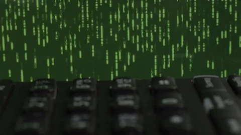 Black phone on desk with green data storm Stock Footage 125565481
