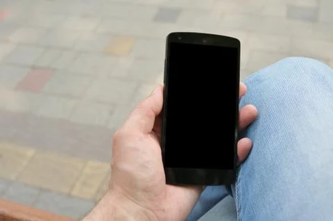 Black phone in hand Stock Photos