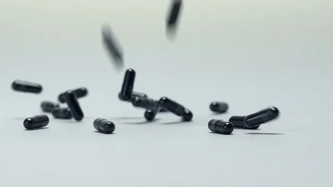 Black pills falling  Stock Footage 106365285