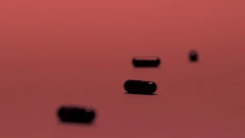 Black pills slow-motion Stock Footage 106365367