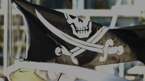 Black pirate flag with skull and crossed swords flying. Stock Footage 254507559