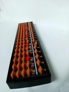 Black plastic abacus with brown and red rows of beads Stock Photos