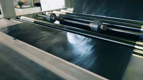 Black plastic bag manufacturing machine in action. Close up Stock Footage 143023944