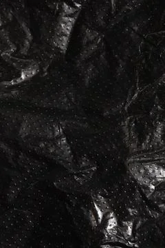 Black plastic bag texture as abstract pattern, macro, background Stock Photos