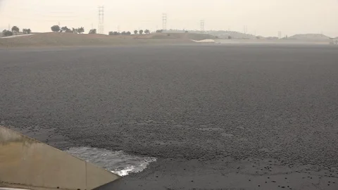Black plastic balls in water to help protect it against dust and evaporation Stock Footage 99050889