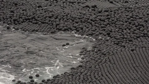 Black plastic balls in water to help protect it against dust and evaporation Video stock 99307659