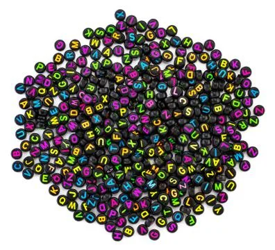 Black plastic beads with colored letters placed randomly Stock Photos