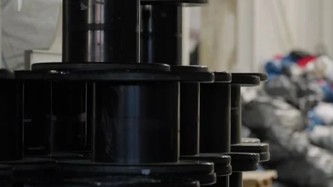 Black plastic cable spools stacked in recycling factory warehouse Stock Footage 334167360