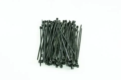 Black plastic cable tie, on isolated white background. Stock-Fotos