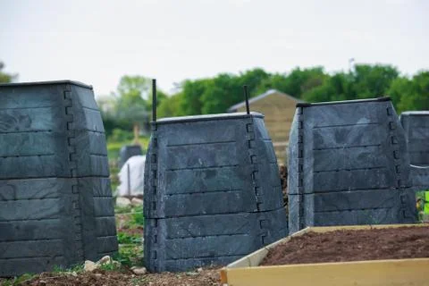 Black plastic compost bin in town garden Stock Photos