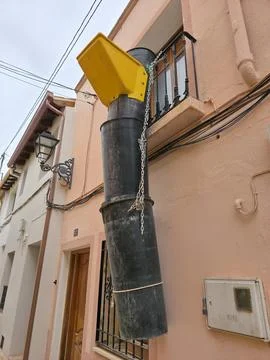 Black plastic construction chute attaches to a balcony for debris removal d.. Stock Photos