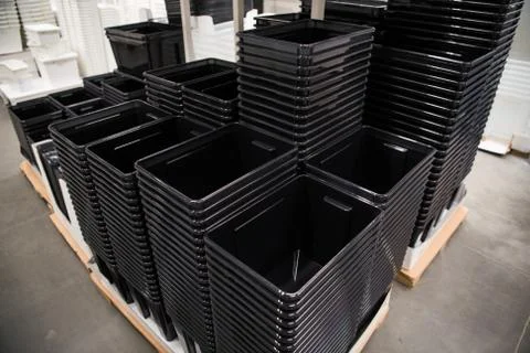 Black plastic containers stack in a store 스톡 사진