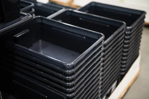 Black plastic containers stack in a store 스톡 사진