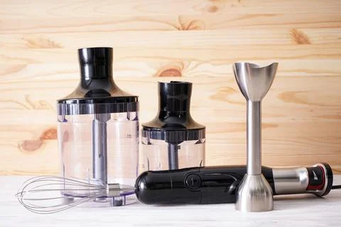 Black plastic electrical hand blender with stainless steel body and accessory Stock Photos