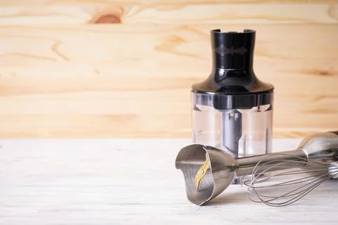 Black plastic electrical hand blender with stainless steel body and accessory Stock Photos