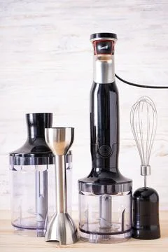 Black plastic electrical hand blender and accessory on the wooden background, Stock Photos